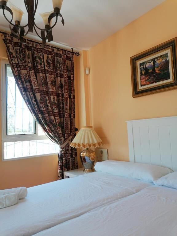 Twin room with window and warm evening light